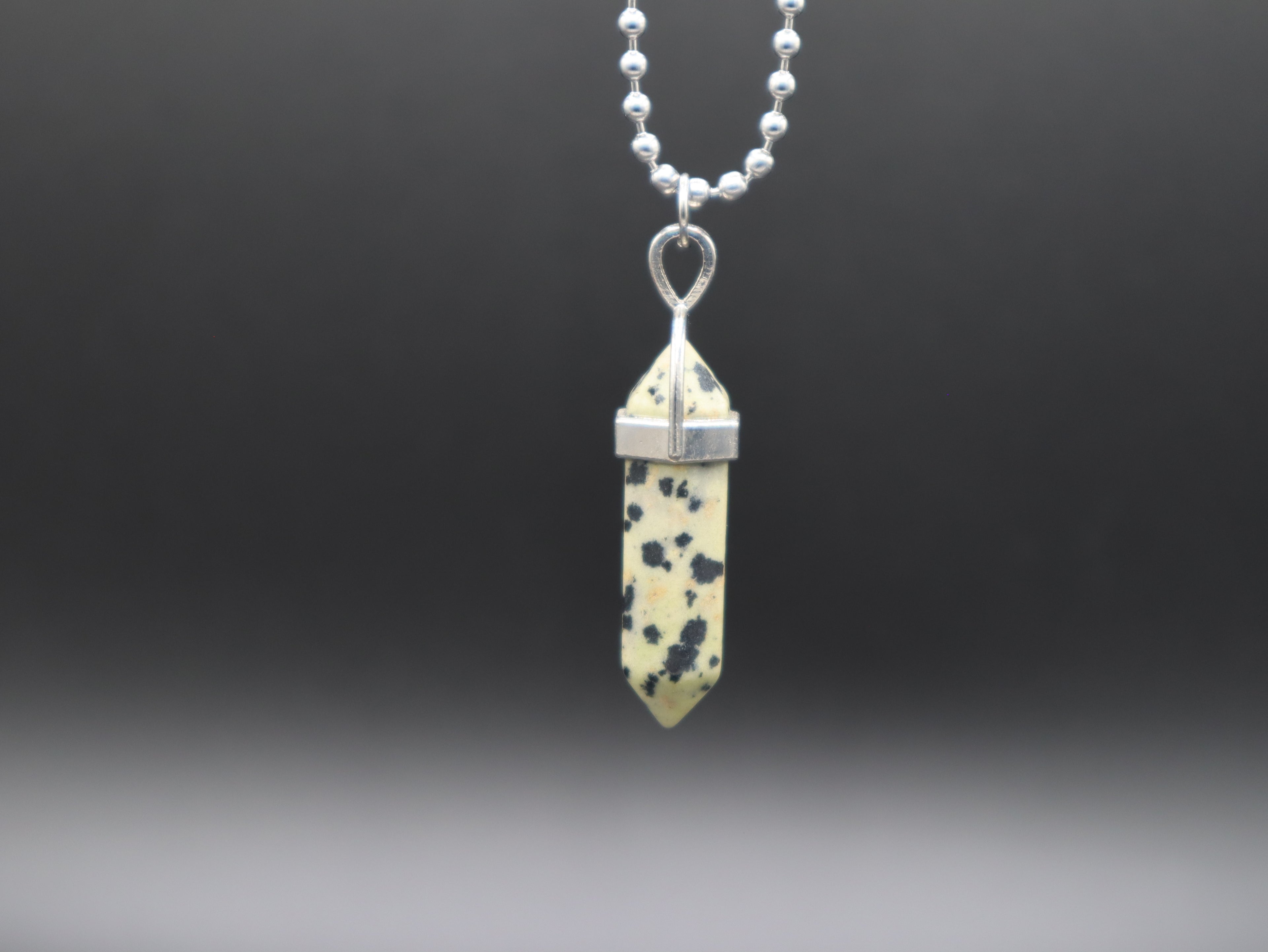 Necklace with a crystal pendant on a dark background