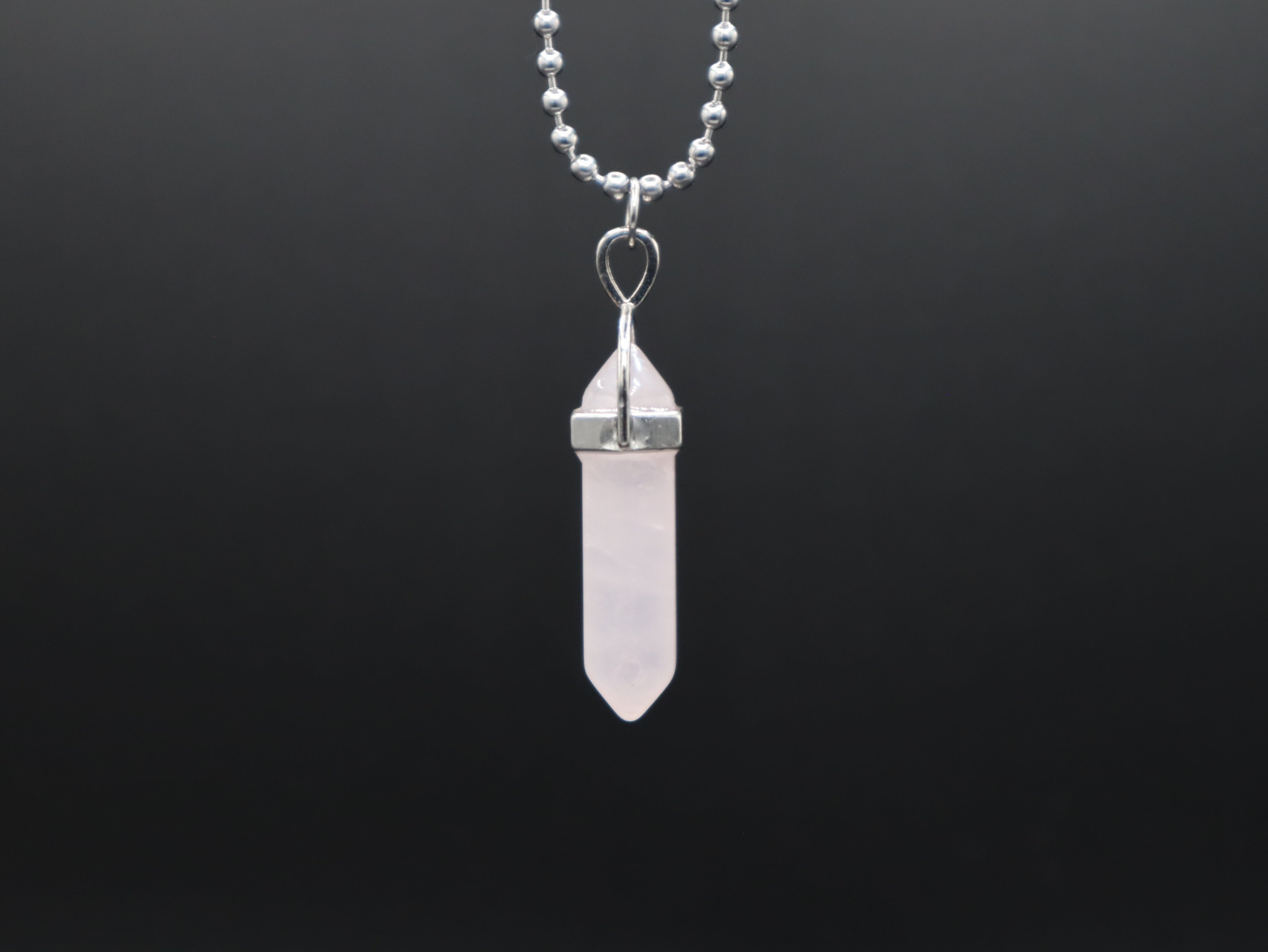 Crystal pendant necklace on a black background