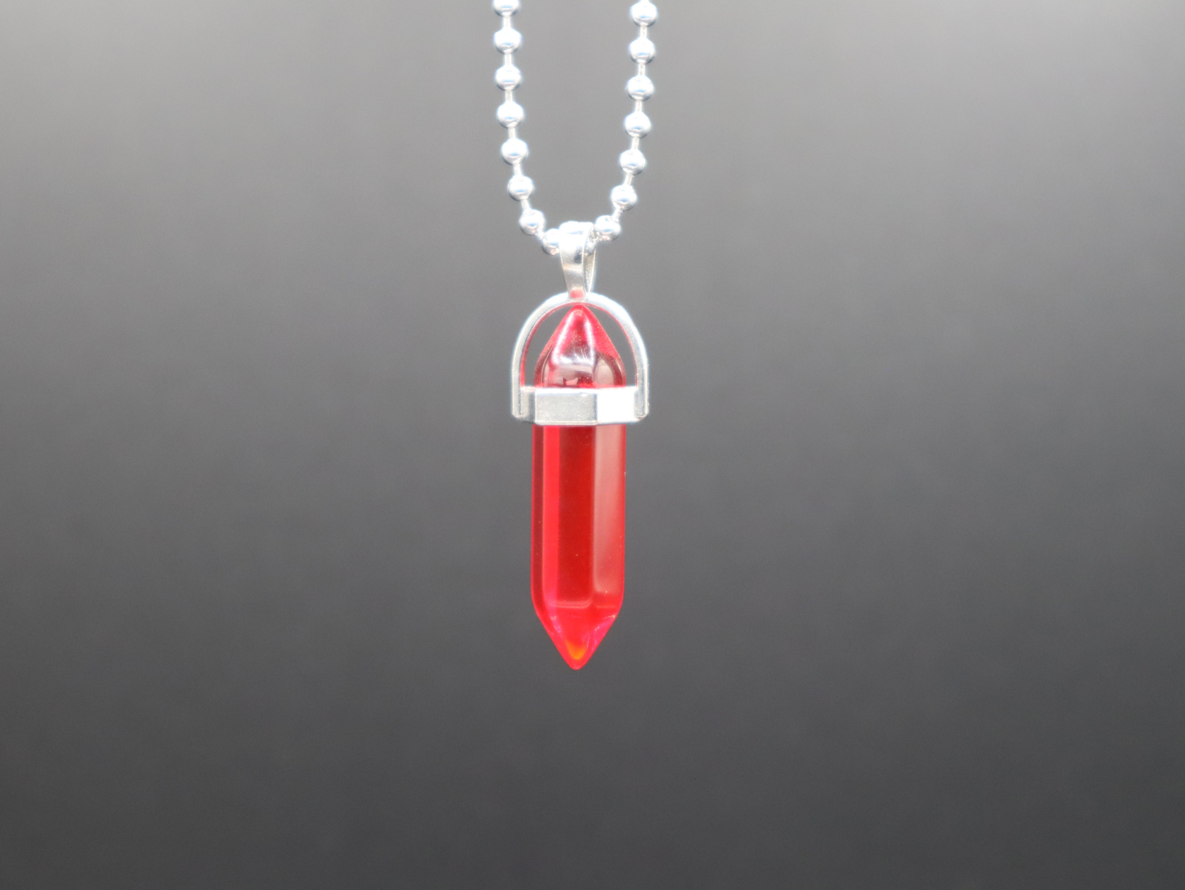 Red crystal pendant necklace on a gray background
